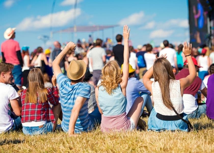 A group of summer concert goers enjoying a music festival. A group of summer concert goers enjoying a music festival.